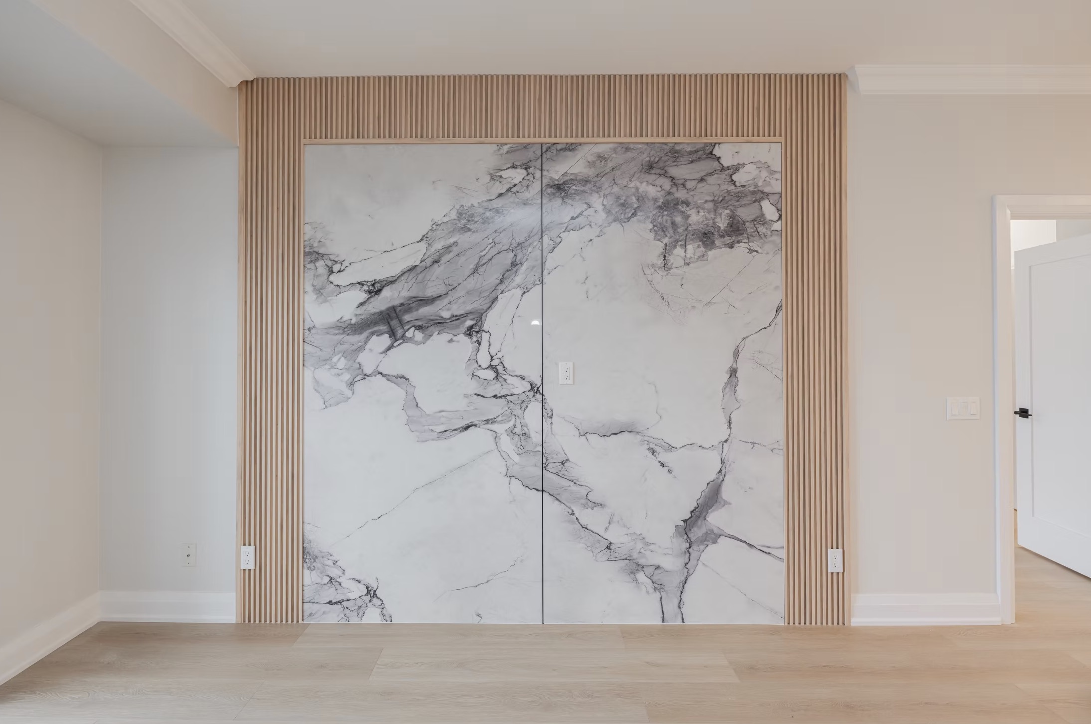Room with double closet doors featuring white/grey marble — European window and door project, Vireo Homes GTA