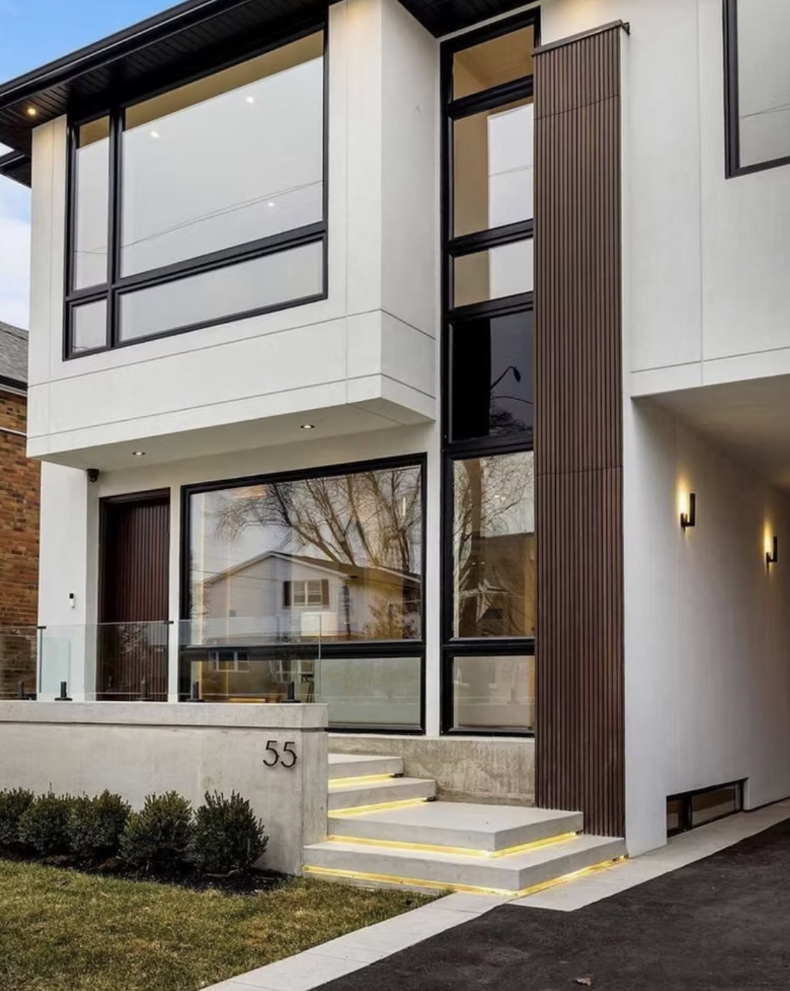 Contemporary white house exterior with large black — European window and door project, Vireo Homes GTA