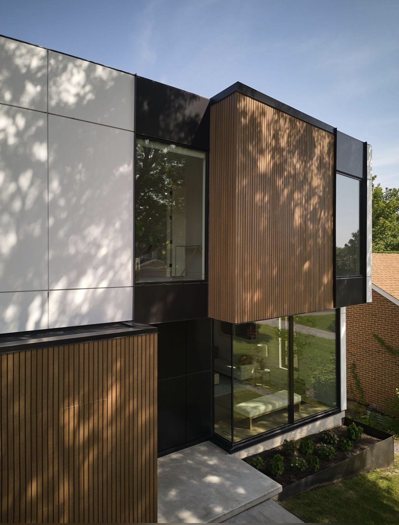 Modern building with white, black, wood slat siding, and large glass — Vireo Homes exterior cladding systems