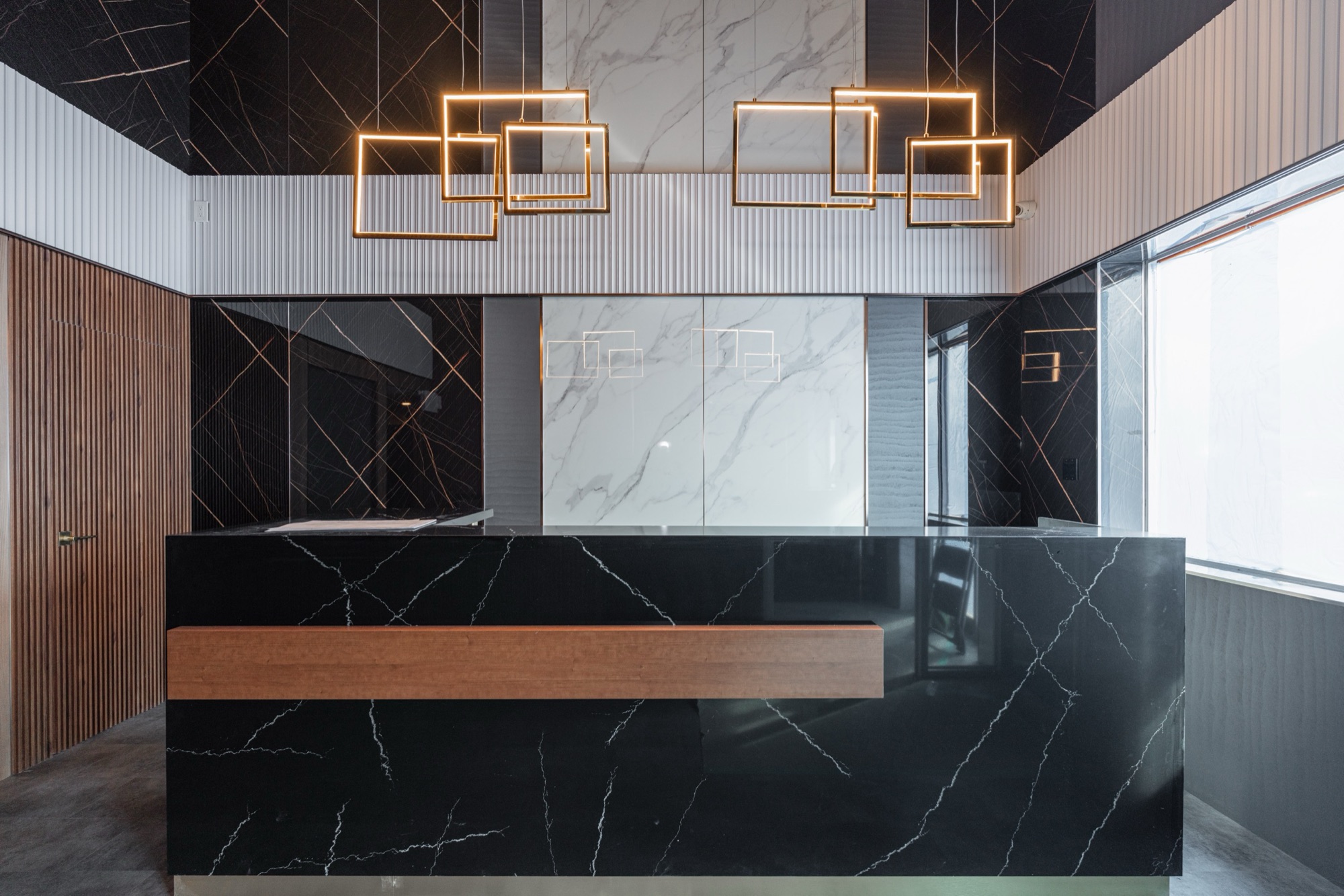 Modern office reception with black marble counter, white — European window and door project, Vireo Homes GTA