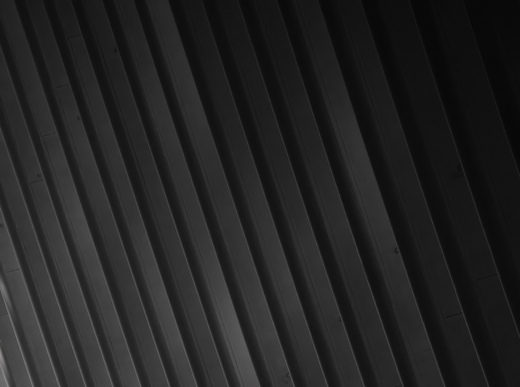 Close-up of dark grey abstract background with diagonal parallel — eco wall panel finish, Vireo Homes
